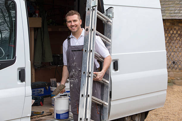 A smiley decorator gets his equipment out of his van ready to work.